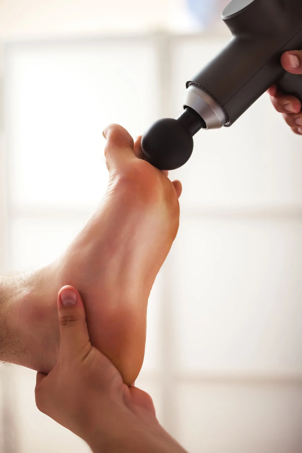 doctor therapist treating injury of foot muscle